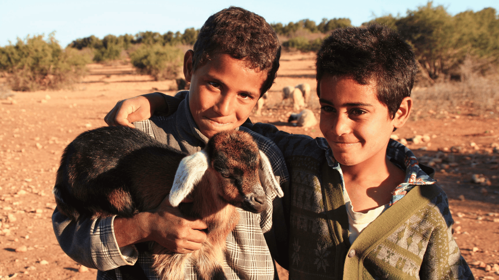 The Amazigh People of Morocco: A Journey Through History and Identity 2 Amazigh people The Amazigh People Of Morocco: Two Amazigh children holding a small sheep, symbolizing rural life and Amazigh family values.